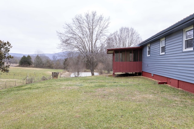 view of yard featuring a mountain view and a sunroom