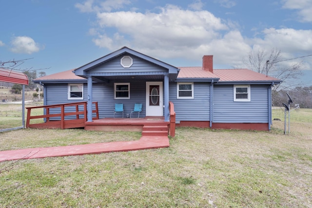 bungalow-style home with covered porch and a front yard