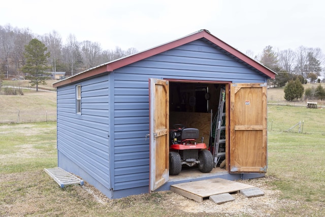 view of outbuilding featuring a lawn