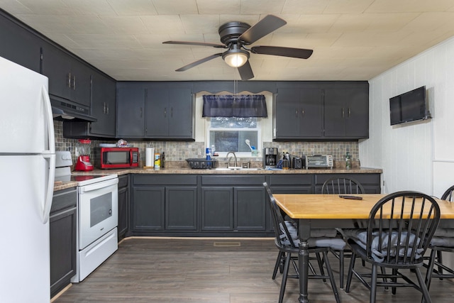 kitchen with white appliances, ceiling fan, dark wood-type flooring, sink, and range hood