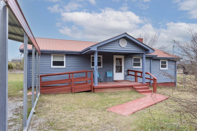 bungalow-style home with covered porch and a front yard