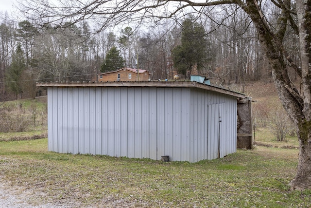 view of outbuilding with a yard