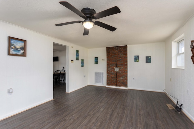 empty room featuring ceiling fan, dark hardwood / wood-style flooring, and a textured ceiling