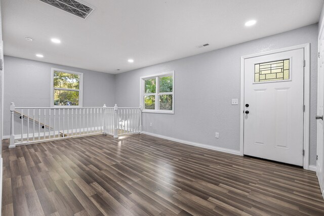 interior space with plenty of natural light and dark hardwood / wood-style flooring