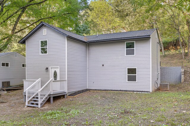 rear view of property with central AC unit