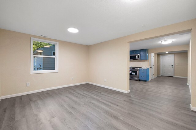 unfurnished room with light wood-type flooring