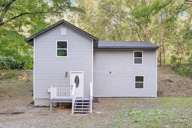 rear view of house featuring central air condition unit and a wooden deck