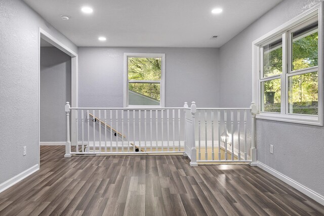 unfurnished room featuring dark wood-type flooring