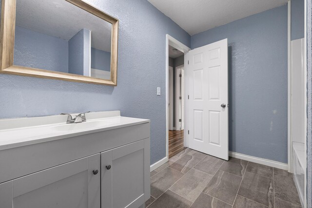 bathroom featuring vanity and a textured ceiling