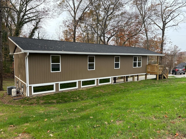 exterior space featuring cooling unit and a lawn