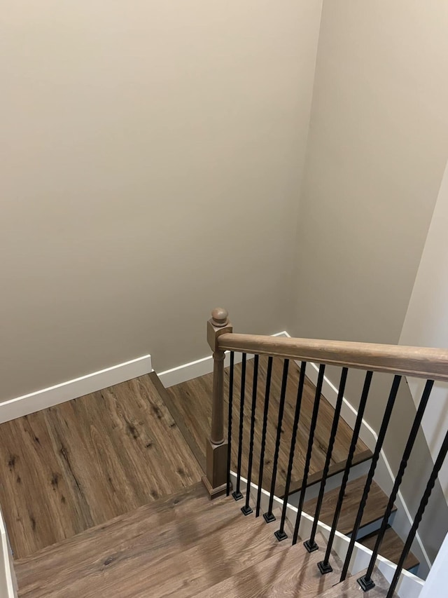 stairway featuring hardwood / wood-style floors