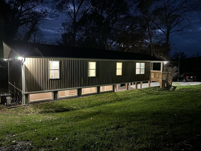 exterior space featuring central AC and a lawn