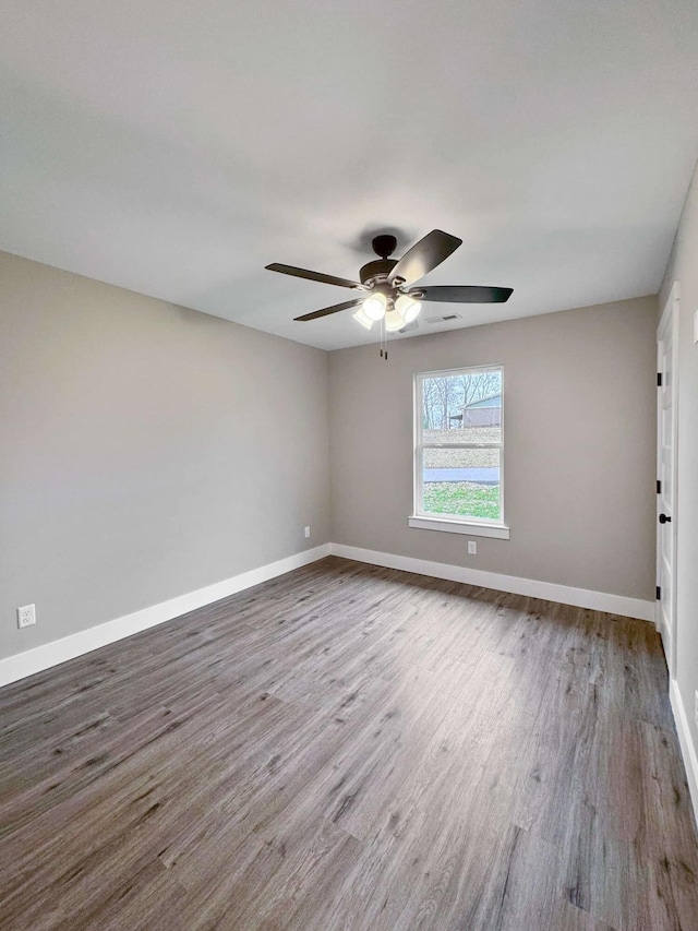 spare room with hardwood / wood-style flooring and ceiling fan