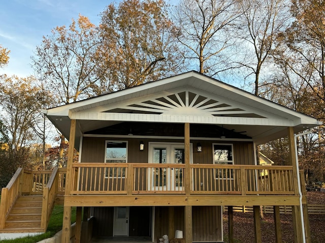 back of property with a deck and ceiling fan