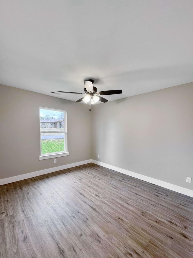 spare room featuring hardwood / wood-style floors and ceiling fan