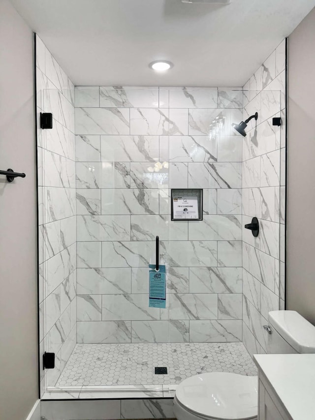 bathroom with vanity, toilet, and an enclosed shower