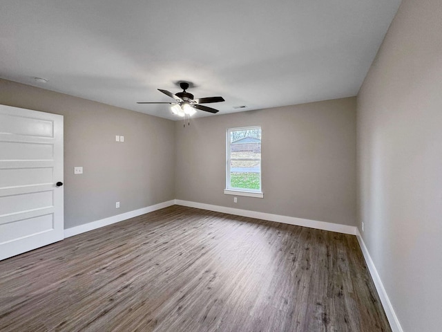 unfurnished room featuring dark hardwood / wood-style floors and ceiling fan