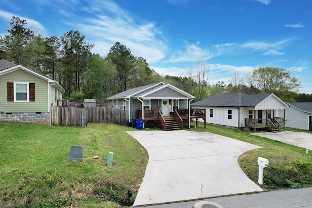1042 Mccann Dr SE, Cleveland, TN 37311 - view of front of home featuring covered porch, concrete driveway, crawl space, and a front lawn