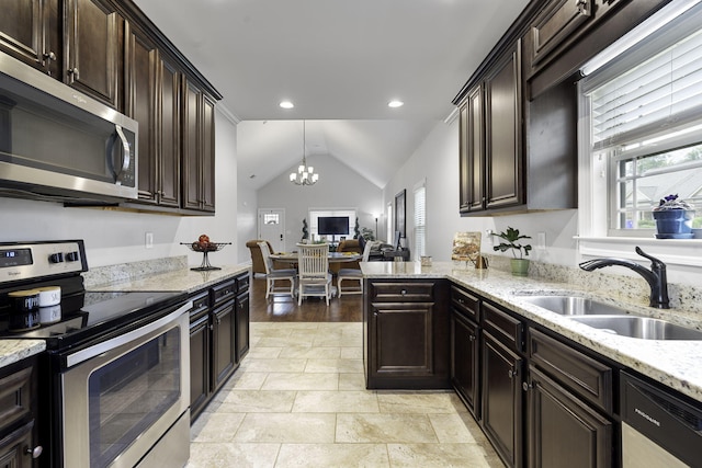 kitchen with sink, stainless steel appliances, an inviting chandelier, pendant lighting, and vaulted ceiling