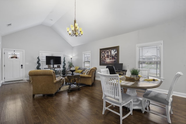 dining room featuring dark wood-type flooring, vaulted ceiling, and a notable chandelier