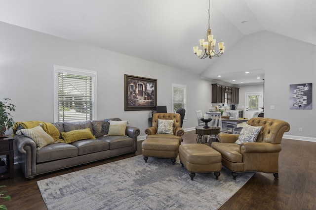 living room featuring dark hardwood / wood-style floors, an inviting chandelier, and lofted ceiling