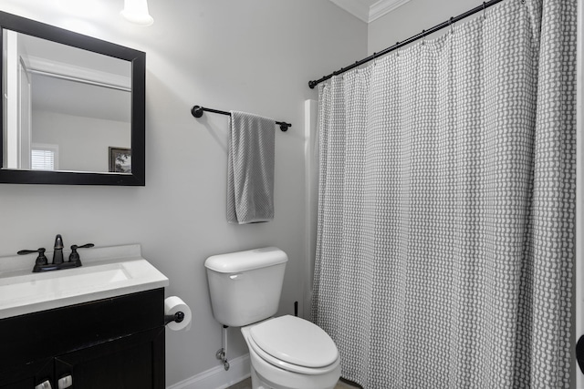 bathroom featuring toilet, vanity, and ornamental molding