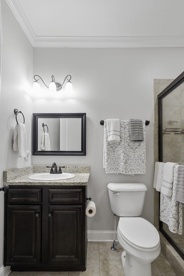 bathroom with vanity, crown molding, tile patterned flooring, toilet, and an enclosed shower