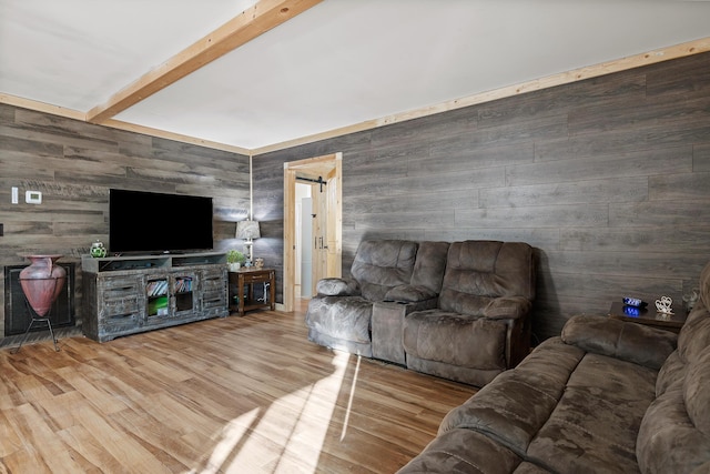 living room with wooden walls, beamed ceiling, and wood-type flooring