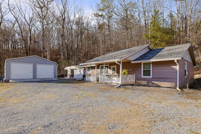 view of front of home featuring an outbuilding, a porch, and a garage