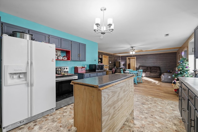 kitchen with ceiling fan with notable chandelier, blue cabinetry, decorative light fixtures, stainless steel electric range oven, and white fridge with ice dispenser