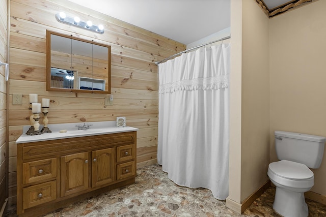 bathroom featuring ceiling fan, a shower with curtain, toilet, wooden walls, and vanity