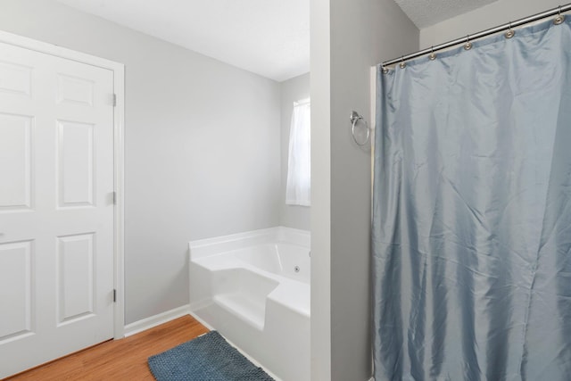 7701 Diamondhead Dr, Ooltewah, TN 37363 - bathroom with a bath, wood finished floors, and curtained shower