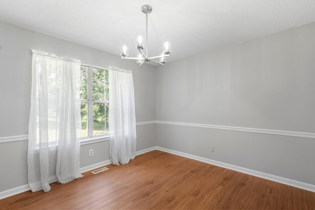 7701 Diamondhead Dr, Ooltewah, TN 37363 - empty room with a chandelier and wood finished floors