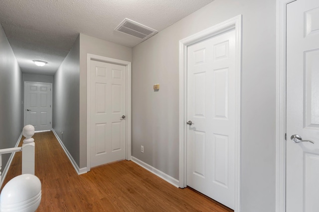 7701 Diamondhead Dr, Ooltewah, TN 37363 - hallway featuring a textured ceiling and wood finished floors