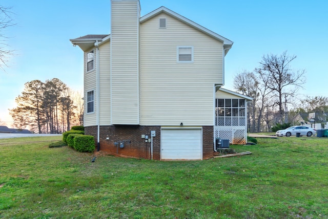 7701 Diamondhead Dr, Ooltewah, TN 37363 - view of property exterior with a sunroom, a lawn, an attached garage, and a chimney