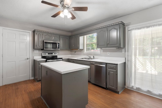7701 Diamondhead Dr, Ooltewah, TN 37363 - kitchen with appliances with stainless steel finishes, gray cabinets, and wood finished floors