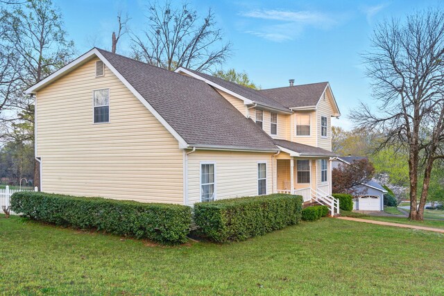 7701 Diamondhead Dr, Ooltewah, TN 37363 - view of side of home featuring an outdoor structure, a lawn, and roof with shingles