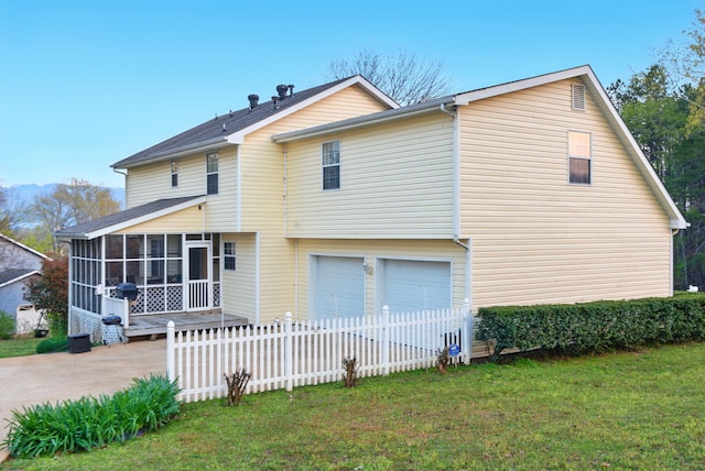 7701 Diamondhead Dr, Ooltewah, TN 37363 - rear view of house with a sunroom, a lawn, an attached garage, and fence