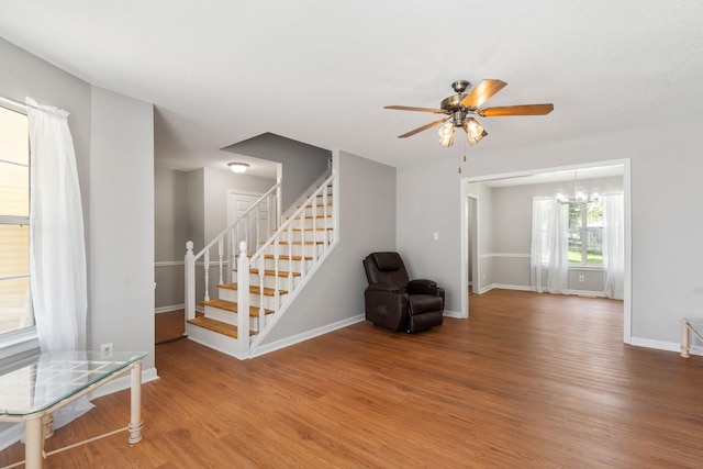 7701 Diamondhead Dr, Ooltewah, TN 37363 - unfurnished room with wood finished floors, a ceiling fan, stairway, and a chandelier