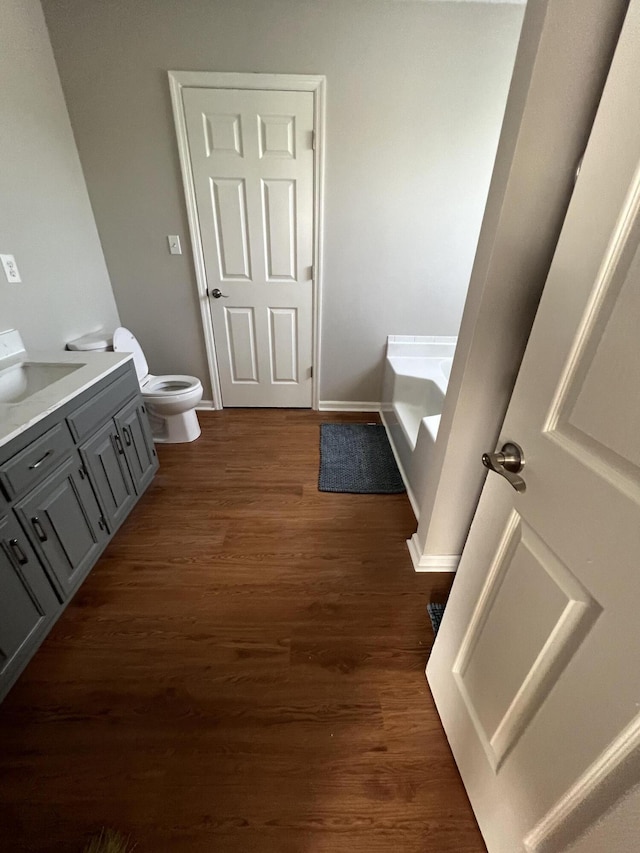 7701 Diamondhead Dr, Ooltewah, TN 37363 - bathroom with vanity, a garden tub, and wood finished floors