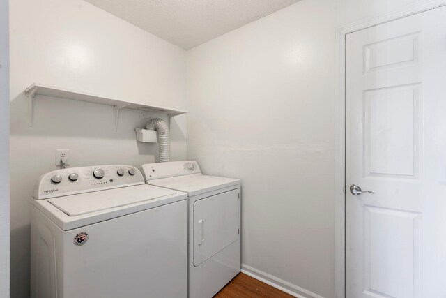 7701 Diamondhead Dr, Ooltewah, TN 37363 - laundry room with washing machine and dryer and dark wood-type flooring