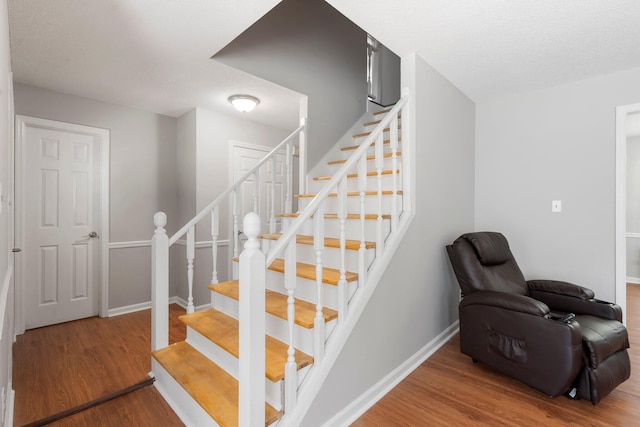 7701 Diamondhead Dr, Ooltewah, TN 37363 - stairs featuring wood finished floors and baseboards