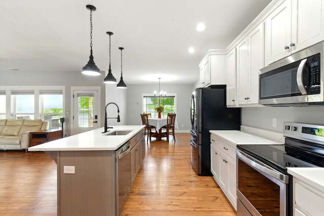 1786 Welcome Valley Rd, Benton, TN 37307 - kitchen featuring light countertops, stainless steel appliances, an island with sink, and a sink
