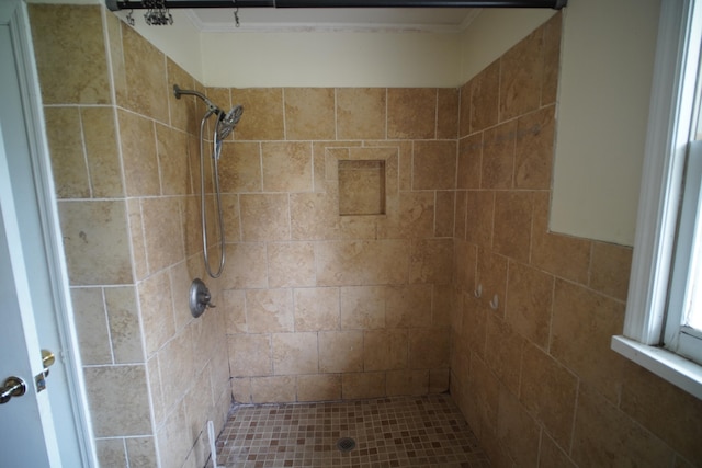 bathroom with a tile shower