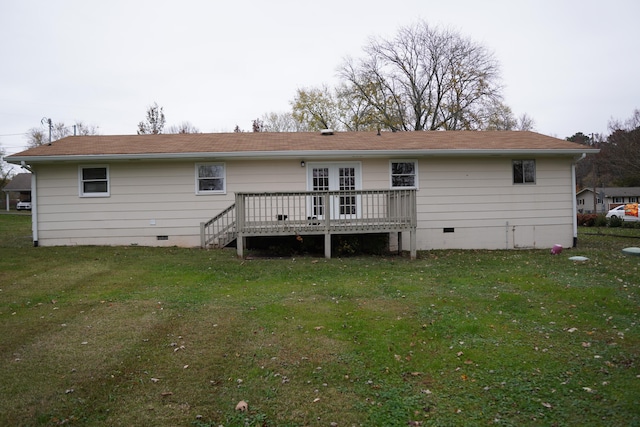 rear view of property featuring a lawn and a wooden deck