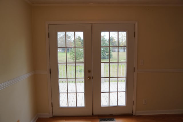 doorway with french doors and light wood-type flooring