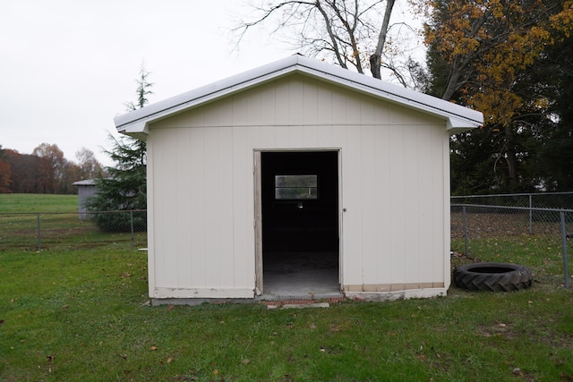 view of outdoor structure featuring a lawn