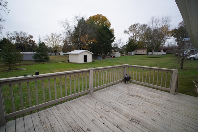 wooden deck featuring a yard and a shed