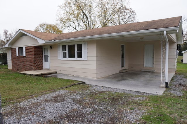 single story home with a carport and a front yard