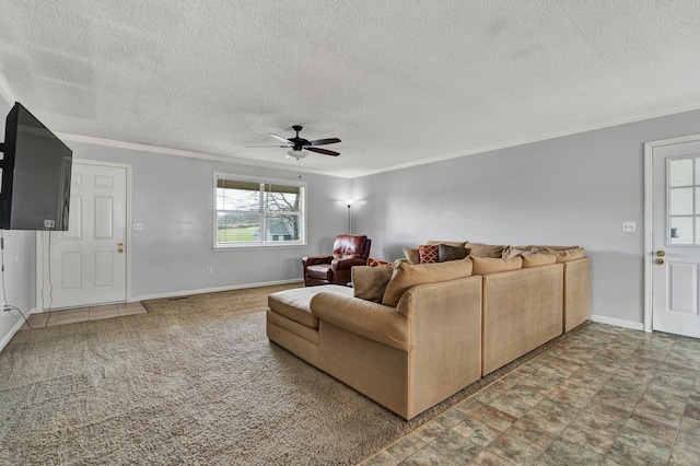 living area with baseboards, ornamental molding, and ceiling fan